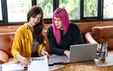 LGBTQ+ transgender man Beautiful Authentic Specialist with Pink Hair and Non-binary trans working together Working Design in creative workplace team work colleagues Gender equality