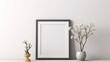 © Valeriia - An empty mockup frame hanging on a pristine white wall, offering a minimalist backdrop for showcasing artwork or photography. AI generated
