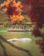 View Of Boat Tour Crossing The Katsura River During Autumn Season From Kameyama Park, Kyoto, Japan.