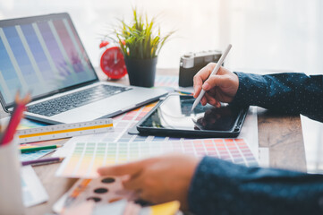 Fototapete - Graphic designer architects who work with laptops and color comparison tables for design work..