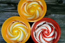 Mango And Strawberry Sauce Ice Cream Frozen Vanilla With Fruit Sauce Like Mangos Or Strawberries Sauces, Top View Of Frozen Ice Creams With Sauce Isolated On Wooden Background, Selective Focus