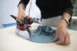 © Tsyb Oleh - a worker irons clothes at a sewing factory