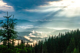 Fototapeta Na ścianę - landscape, the sky after a thunderstorm, clouds in the mountains after the rain, a ray of the sun, light, the sun rises, morning, fog, above the clouds, wallpaper, poster, cover, the nature