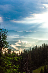 Wall Mural - landscape, the sky after a thunderstorm, clouds in the mountains after the rain, a ray of the sun, light, the sun rises, morning, fog, above the clouds, wallpaper, poster, cover, the nature