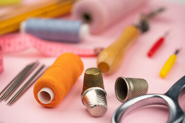 Wall Mural - various tailor accessories and tools for tailoring on a pink background