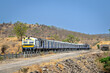 Local passenger train passing through hilly railway line in Daundaj, Maharashtra, India