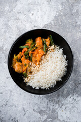 Wall Mural - Boiled rice with stew, broccoli, green beans, tomatoes and onions in a bowl, Asian food.