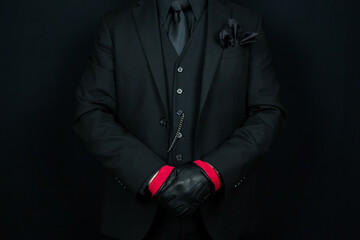 Wall Mural - Portrait of Man in Black Suit and Leather Gloves. Concept of Mafia Hit Man.