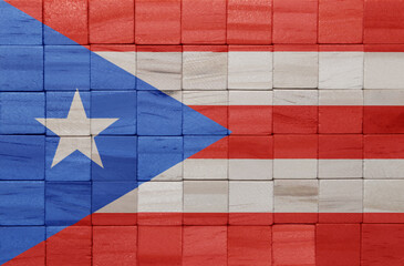 Wall Mural - colorful painted big national flag of puerto rico on a wooden cubes texture.