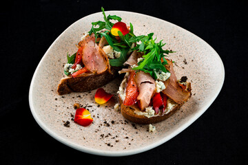 Wall Mural - Bruschettas with bacon, sweet pepper, blue cheese and arugula, restaurant menu.