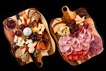 Banquet Meat And Cheese Boards With Slices Of Sausage, Ham, Parmesan, Gouda, Mozzarella, Sun-dried Tomatoes And Bread.