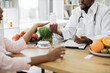 © Sofiia Shunkina - Crop of male dietitian providing expert check-up and giving nutritional supplements to female patient in hospital office. Woman listening attentively to recommendations and reaching hand for tablets.