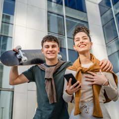 modern brother and sister or couple young man and woman walk outdoor