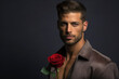 © piai - Studio style photo of a Handsome mediterranean male model with beautiful eyes, holding a red rose. Generative AI