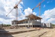 © altitudevisual - construction site with crane lifting concrete blocks in the air, created with generative ai