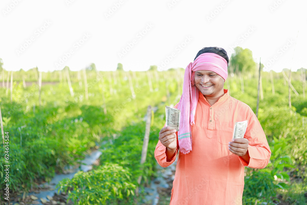 Happy Indian farmer, farmer holding indian rupees in hands, smart ...