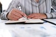 © Charlie's - Business woman analyzing investment charts and pressing calculator buttons over documents. Accounting Concept.
