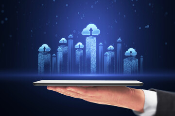 Poster - Data storage and cloud computing service concept with blue glowing city skyscrapers visualization with cloud icons above digital tablet in businessman hand on dark background