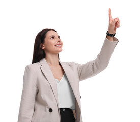 Canvas Print - Beautiful businesswoman in suit pointing at something on white background, low angle view