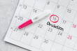Female ovulation day on calendar with pregnancy test