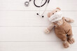 Teddy bear in medical mask and stethoscope - child illness concept