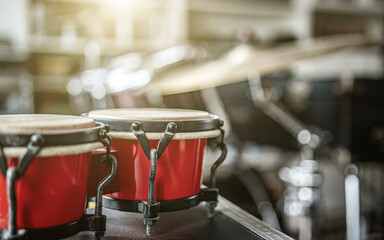 Wall Mural - Red bongos drums in recording studio for hard beat perfomance. Professional musical instrument for rock concerts