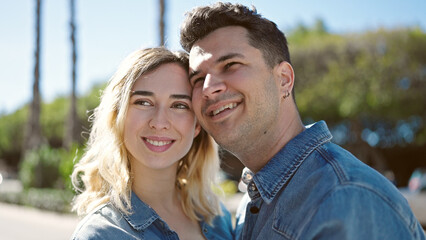 Canvas Print - Man and woman couple smiling confident standing together at park