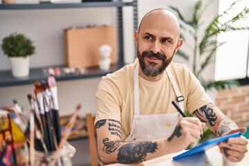 Sticker - Young bald man artist smiling confident drawing on touchpad at art studio