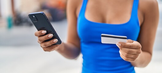 Sticker - Young beautiful latin woman using smartphone and credit card at street