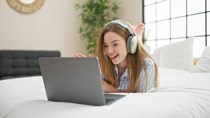 Poster - Young blonde woman doing video call lying on the bed at bedroom