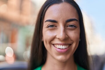 Wall Mural - Young beautiful hispanic woman smiling confident standing at street