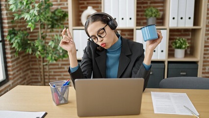 Canvas Print - Young beautiful hispanic woman business worker using laptop working dancing at office