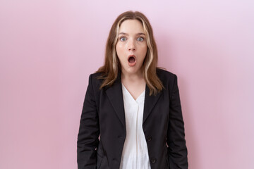 Sticker - Young caucasian business woman wearing black jacket afraid and shocked with surprise and amazed expression, fear and excited face.