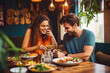© VisualProduction - Young couple eating indian food at restaurant. Couple on date night with delicious food. Generative AI