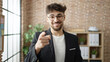 © Krakenimages.com - Young arab man business worker smiling confident pointing with finger to camera at office