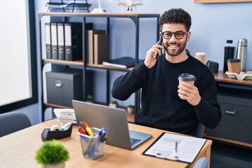 Canvas Print - Young arab man business worker talking on the smartphone working at office