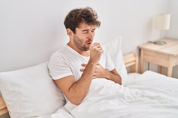 Sticker - Young man sitting on bed coughing at bedroom