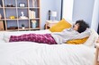 © Krakenimages.com - Young middle east woman relaxed with hands on head lying on bed at bedroom