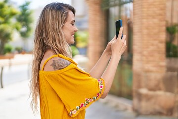 Canvas Print - Young woman smiling confident making photo by the smartphone at street