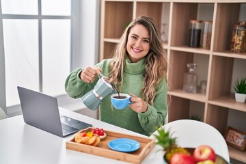 Poster - Young woman using smartphone having breakfast at home