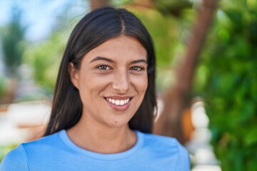 Canvas Print - Young beautiful hispanic woman smiling confident standing at park