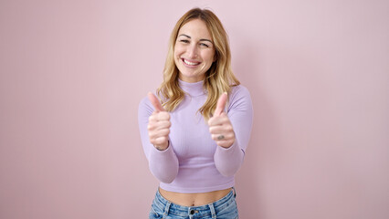 Sticker - Young beautiful hispanic woman smiling with thumbs up over isolated pink background