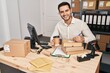 © Krakenimages.com - Young hispanic man e-commerce business worker drinking coffee write on package at office