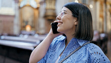 Young Beautiful Hispanic Woman Visiting Church Speaking On The Phone At St. Karl BorromÃ¤us Church