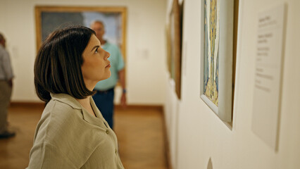 Young beautiful hispanic woman visiting art gallery at Belvedere Palace in Vienna