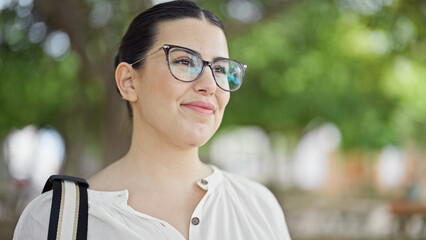 Wall Mural - Young beautiful hispanic woman smiling confident standing at the park