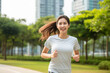 © BrightSpace - Vibrant Midlife Woman Exercising Outdoors: Beautiful Lady portrait people jogging with Freshness in Urban Park with Trees and Buildings with bright sun and nature light, healthy concept, gen ai