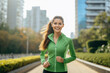 © BrightSpace - Vibrant Midlife Woman Exercising Outdoors: Beautiful Lady portrait people jogging with Freshness in Urban Park with Trees and Buildings with bright sun and nature light, healthy concept, gen ai