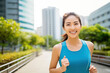 © BrightSpace - Vibrant Midlife Woman Exercising Outdoors: Beautiful Lady portrait people jogging with Freshness in Urban Park with Trees and Buildings with bright sun and nature light, healthy concept, gen ai