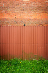 Wall Mural - Red brick and tin wall background with green grass